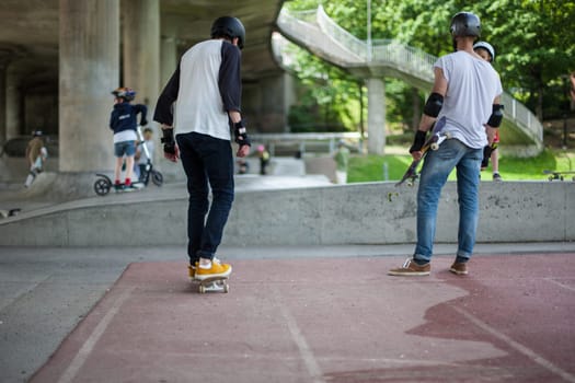 Powerful funny young guys are trained in a skate park Stockholm, Sweden. Leisure, playing, trick