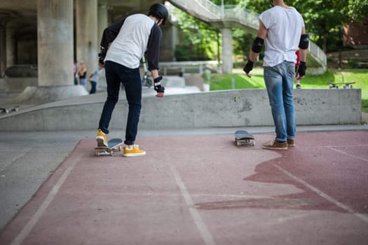 Powerful funny young guys are trained in a skate park Stockholm, Sweden. Leisure, playing, trick