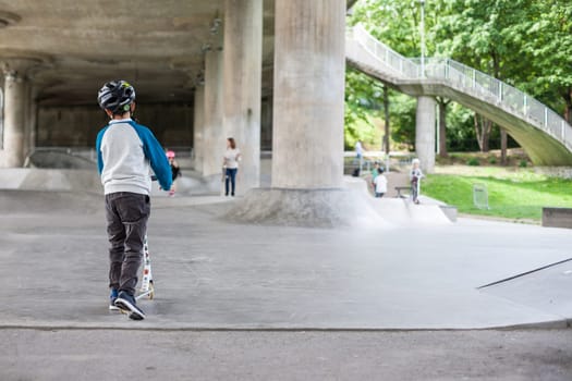 Powerful funny young guys are trained in a skate park Stockholm, Sweden. Leisure, playing, trick