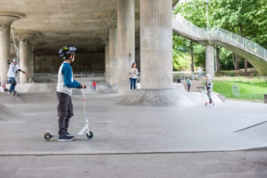 Powerful funny young guys are trained in a skate park Stockholm, Sweden. Leisure, playing, trick