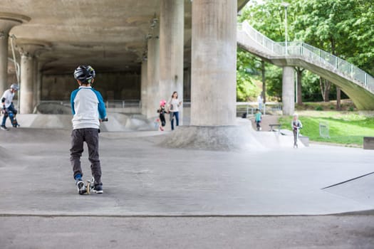 Powerful funny young guys are trained in a skate park Stockholm, Sweden. Leisure, playing, trick