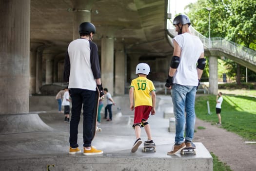 Powerful funny young guys are trained in a skate park Stockholm, Sweden. Leisure, playing, trick