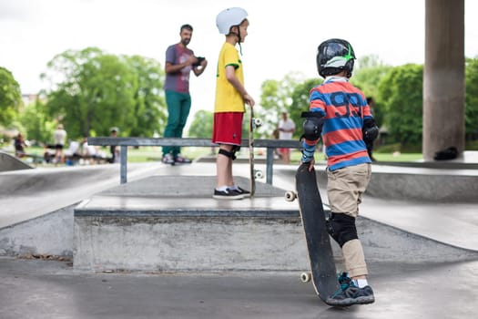 Powerful funny young guys are trained in a skate park Stockholm, Sweden. Leisure, playing, trick