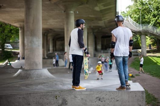 Powerful funny young guys are trained in a skate park Stockholm, Sweden. Leisure, playing, trick
