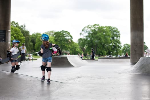 Powerful funny young guys are trained in a skate park Stockholm, Sweden. Leisure, playing, trick