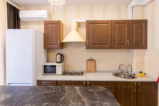 The interior of a modern budget kitchen in a newly built apartment