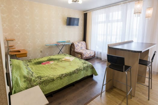 Interior of a bedroom with a sofa in a one-room apartment
