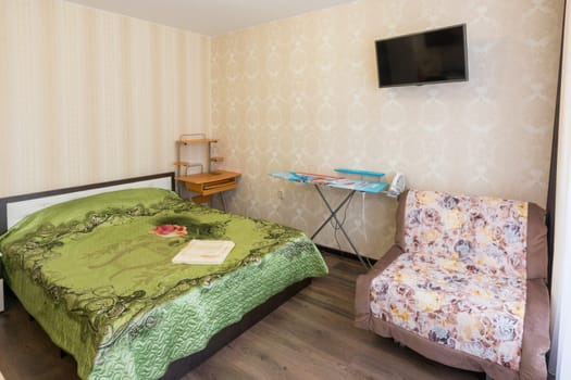 Interior of a bedroom with a sofa in a one-room apartment