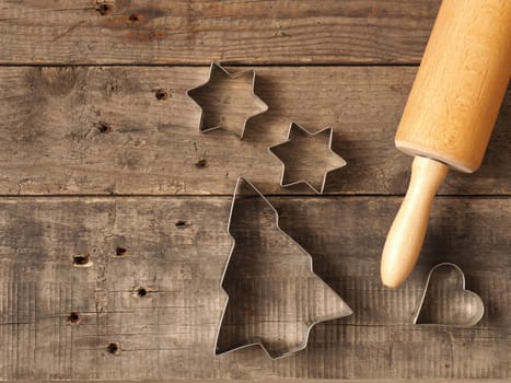 Christmas bakery background, baking tin and rolling pin on an old wooden table