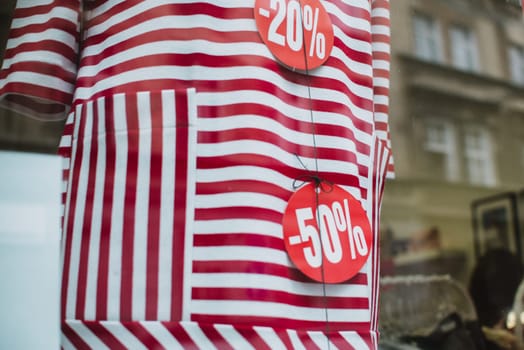 discount price on the red dress. outside the window with city reflection