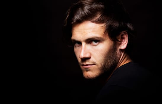 Close-up face of young bearded man on dark background modern and dramatic photo