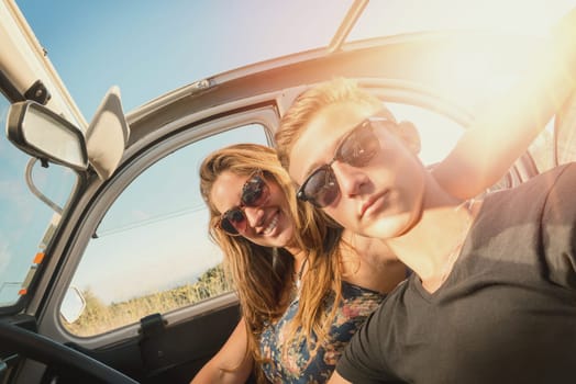 Young couple in a retro car at sunset, retro style.