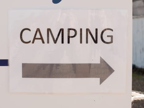 close up of printed direction white and black sign camping  essex  england  UK