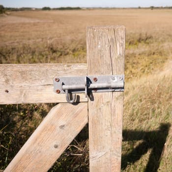 close up of metal lock on wooden country gate  essex  england  UK