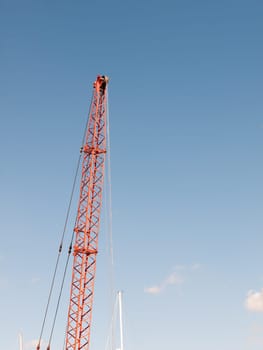 red crane top reaching into the blue sky above  essex  england  UK