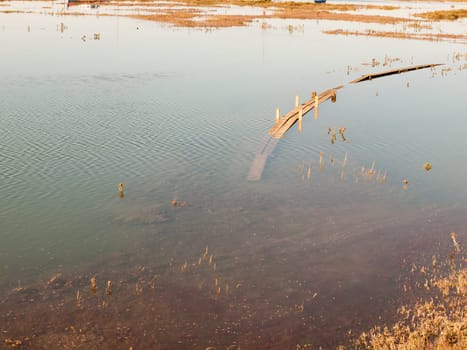 submerged wooden walkway in dockland in sea water  essex  england  UK
