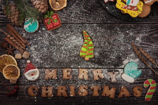 Gingerbreads for new years and christmas on wooden background with space for design