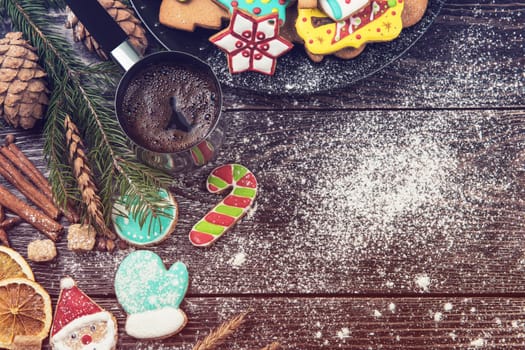 Different ginger cookies and coffee for new years and christmas on wooden background, xmas theme. Top view.