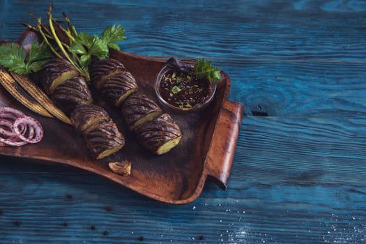 Grilled potato on a blue wooden background