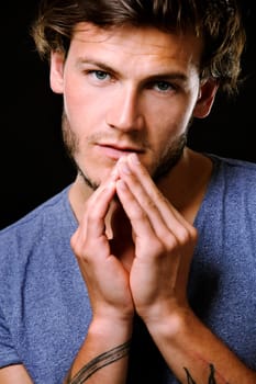 Close-up face of young bearded man on dark background modern and dramatic photo