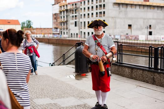 Poland, Gdansk - June 12, 2017 : Urban life. Old man dressed as pirate in A Big City Street