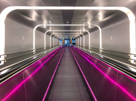 Norway, Oslo - JUNE 08, 2017: Neon escalator tunnel in Train Station