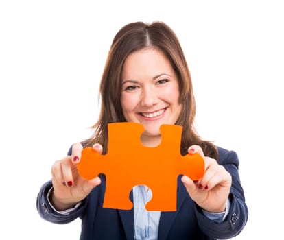 Business woman holding a puzzle piece, isolated over white