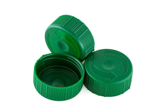 Three green plastic bottle caps isolated on white nackground