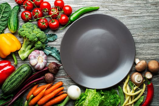 Various fresh vegetables and ingredients on wooden rustic background