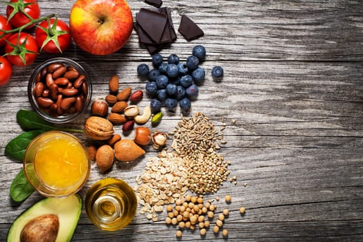 Selection of healthy food on wooden background. Healthy diet foods for heart cholesterol and diabetes