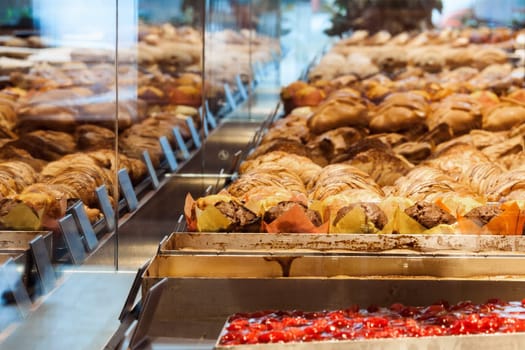 Variations croissants and other pastries exhibited in shop window
