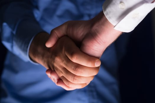 Two Businessman Handshake Handshaking between darkness and light
