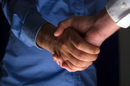 Two Businessman Handshake Handshaking between darkness and light