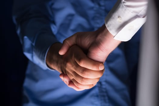 Two Businessman Handshake Handshaking between darkness and light