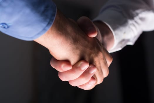 Two Businessman Handshake Handshaking between darkness and light
