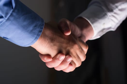 Two Businessman Handshake Handshaking between darkness and light