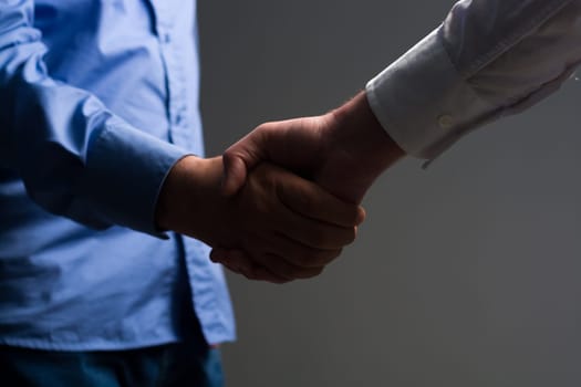 Two Businessman Handshake Handshaking between darkness and light
