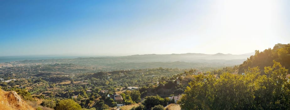Panoramic view of sunrise over the village and green landscape in Mijas, Spain