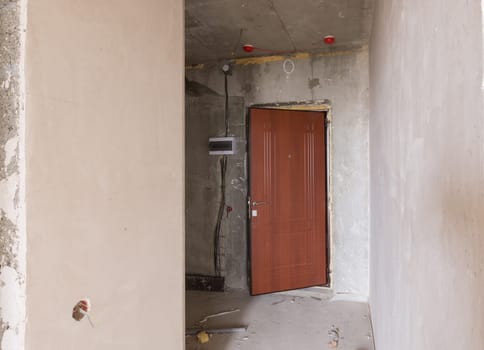 Entrance to the premise in the new building, installed metal door and electric guard
