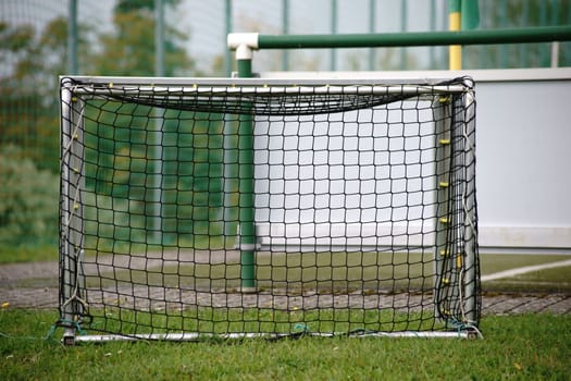 A small football goal for training on a sports field.