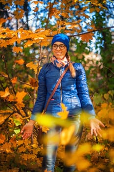 Beauty woman at autumn park in sunny beauty day