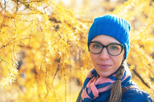 Beauty woman at autumn park in sunny beauty day