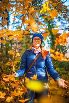 Beauty woman at autumn park in sunny beauty day