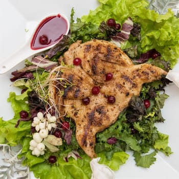 quail roasted with sweet and sour cranberry sauce decorated with rowanberry