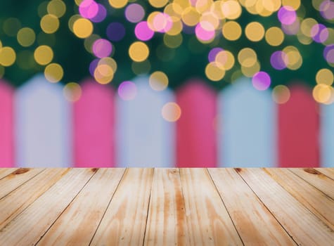 Empty wooden table top with blur white red wall and Christmas bokeh lights background, can be used for montage or display your products