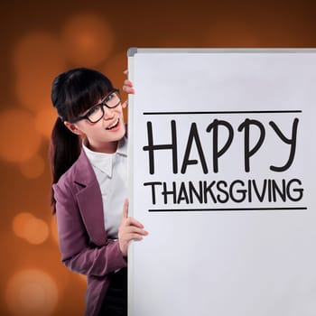 Asian woman smiling show happy thanksgiving writing on the whiteboard
