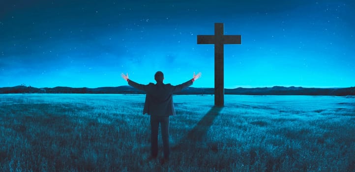 Man standing in the middle of the meadow, praying. Religion concept