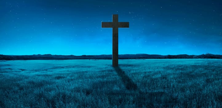 Christian cross in the middle of meadow. Religion concept