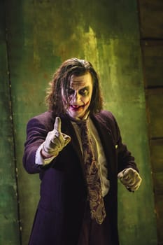 Bloody Halloween theme: The crazy maniak face on dark studio background