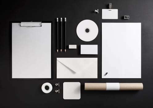 Blank corporate stationery set on black paper background. Branding mock-up.